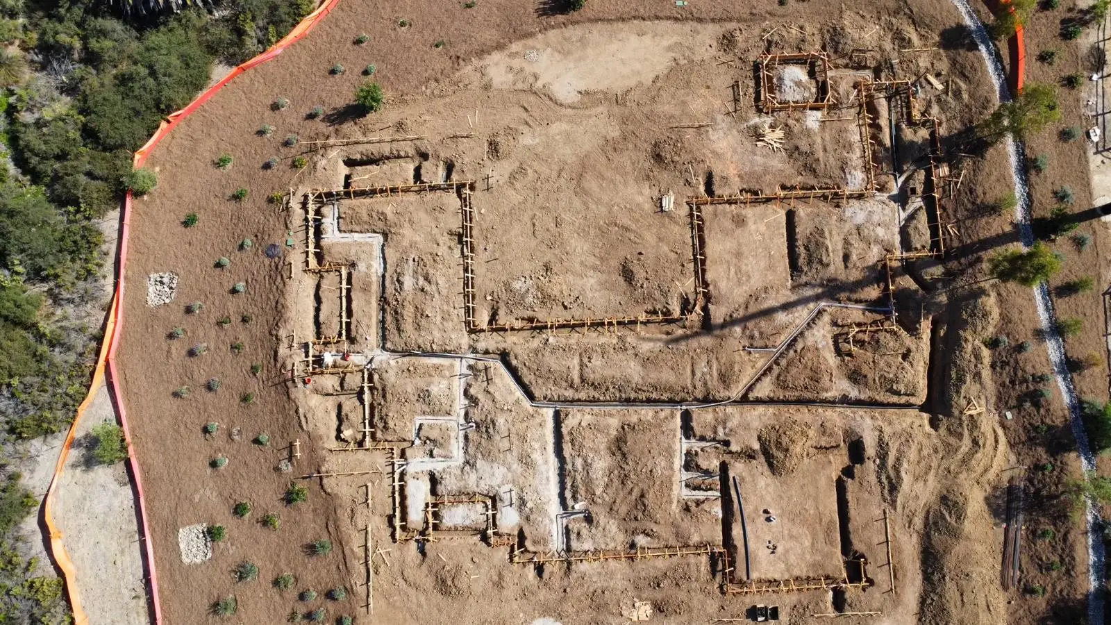 Aerial view of footing excavations and forms laid out across the building footprint