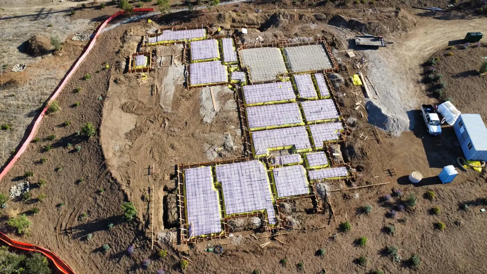 Aerial view of foundation bays with vapor retarder and reinforcing in progress