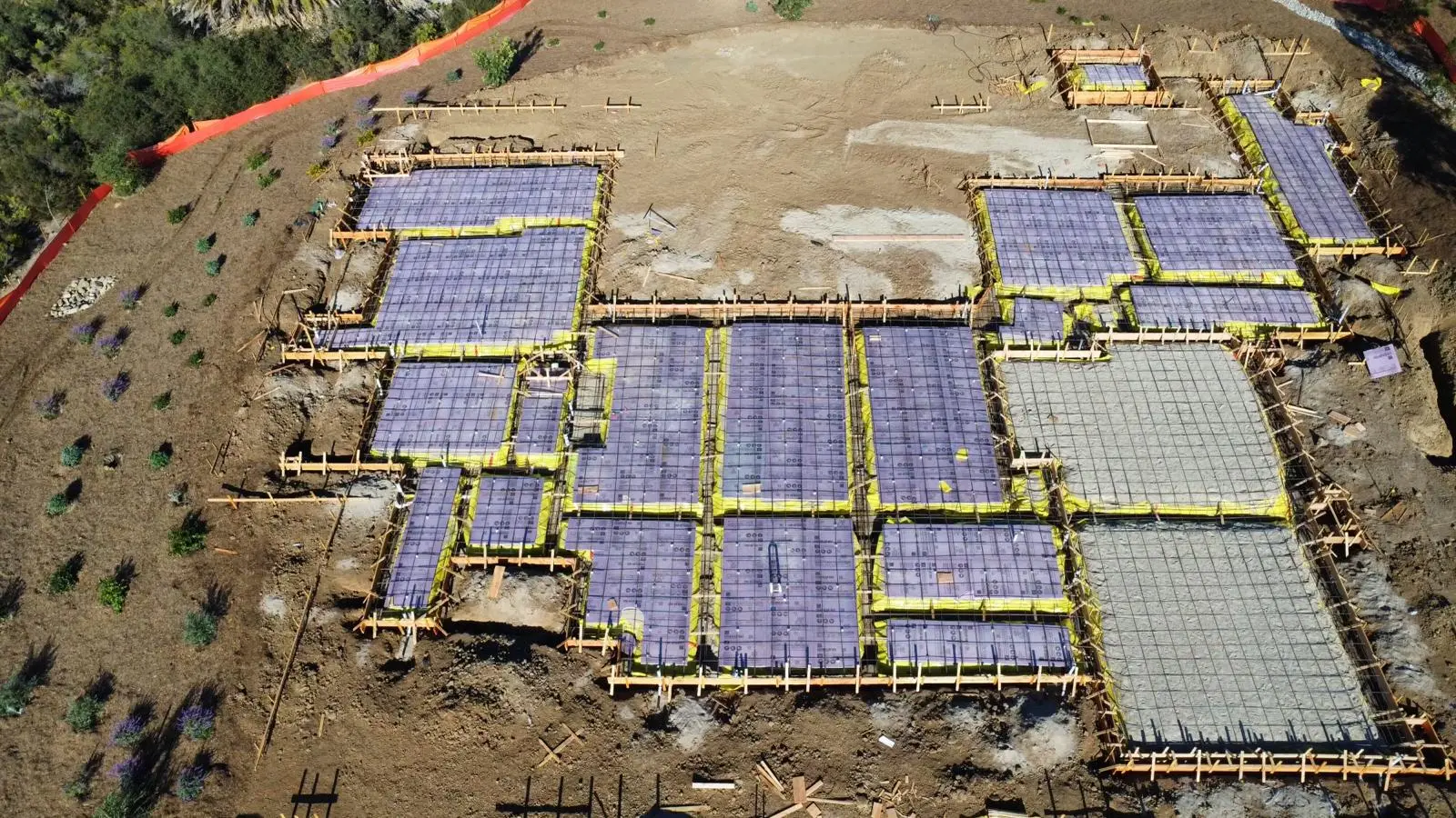 Aerial view of a Cal-Crete foundation project with reinforcing mats and completed slab sections