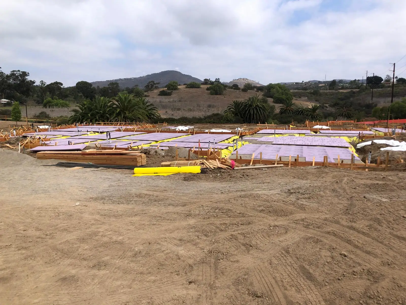 Ground-level view of formed and reinforced foundation areas