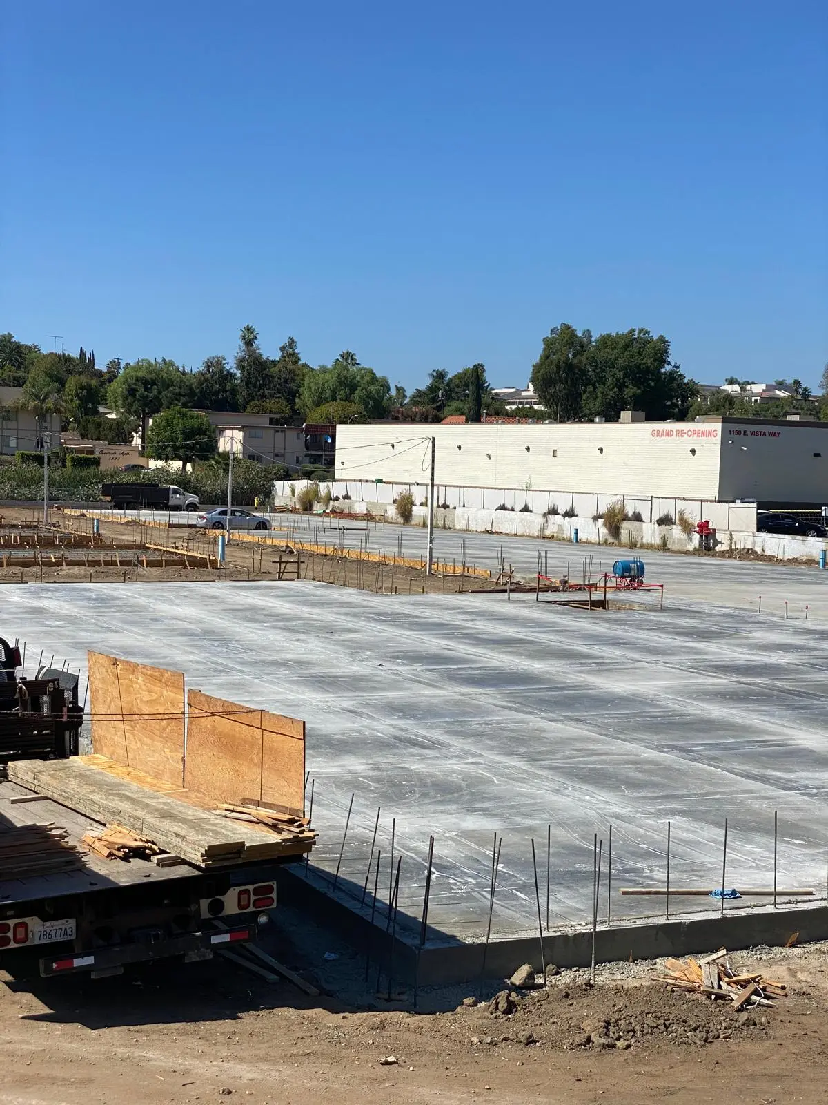 Organized job site with a completed slab and staged materials