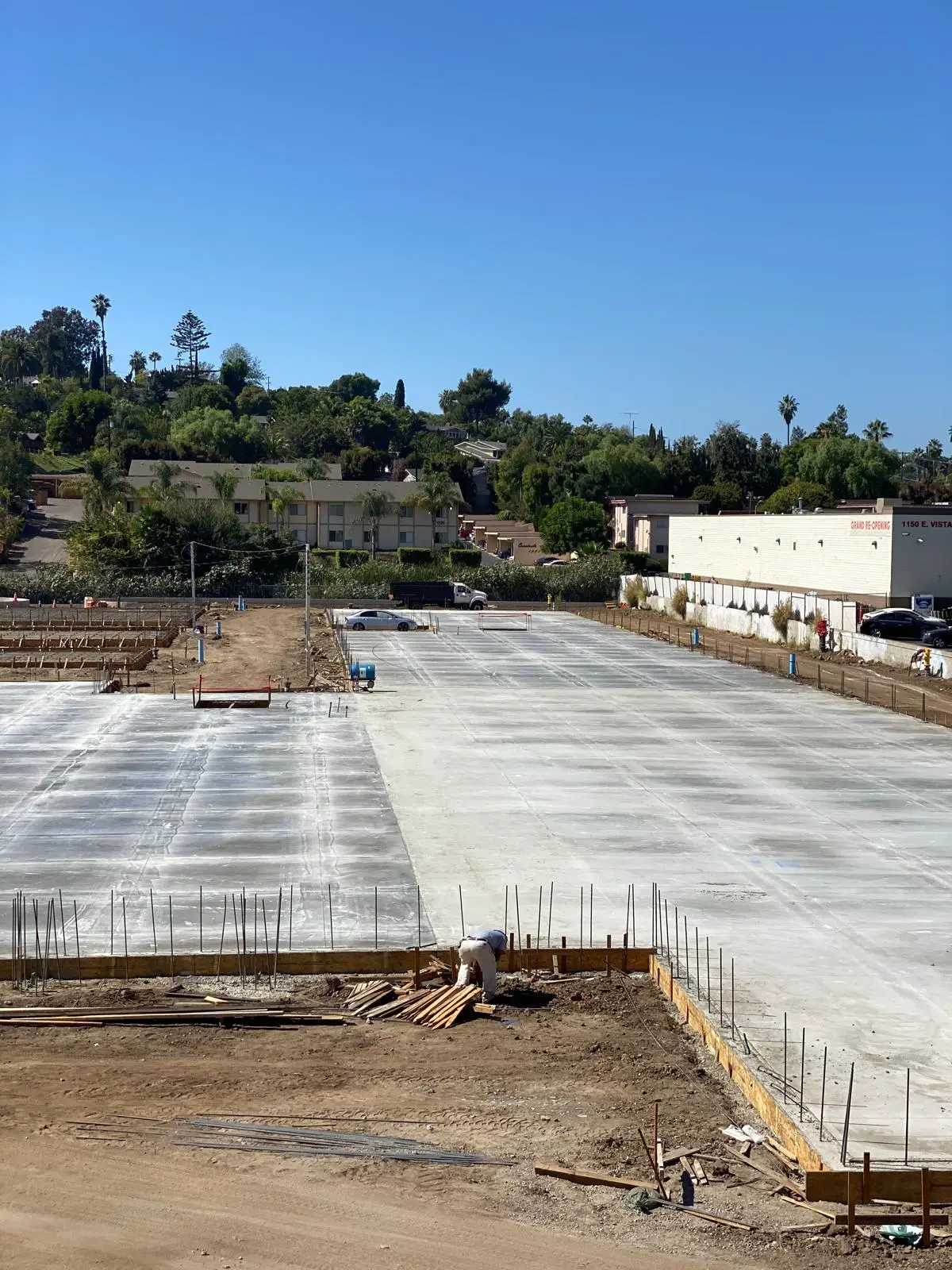Two adjoining finished slab-on-grade placements with dowels at a commercial construction site