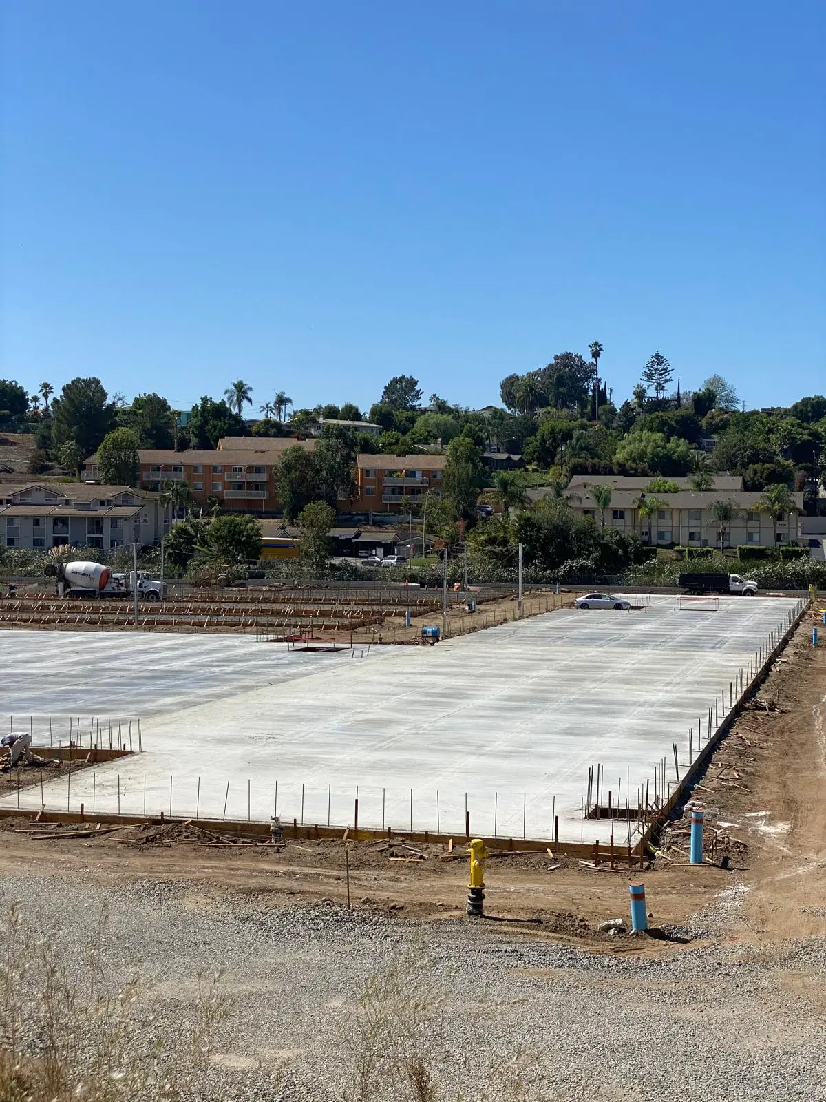 Completed slab-on-grade with reinforcing dowels and a clean, organized site
